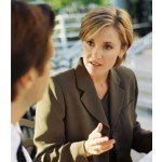 Woman Communicating to Man in Foreground