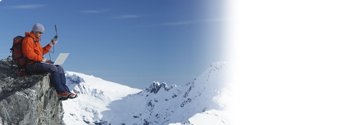 Man Using Laptop on Mountain