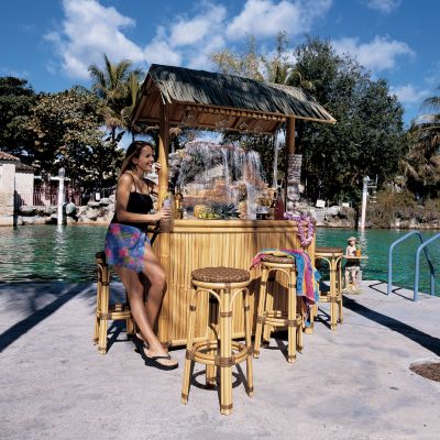 Thatch-Roofed Tiki Bar with Four Stools