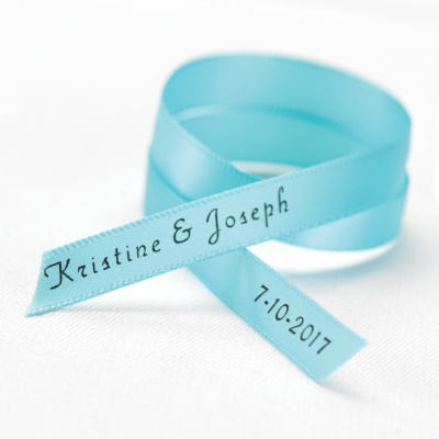 narrow aqua blue wedding favor ribbon personalized with the names and wedding date of bride and groom